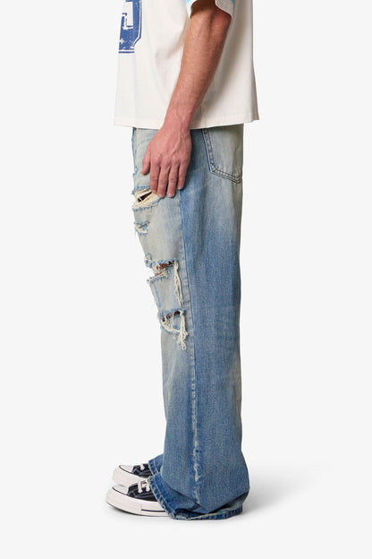 COWBOY DISTRESSED KICK FLARE DENIM